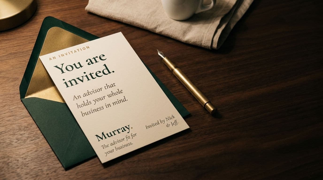 A Murray invitation card resting on its green envelope beside a brass pen.